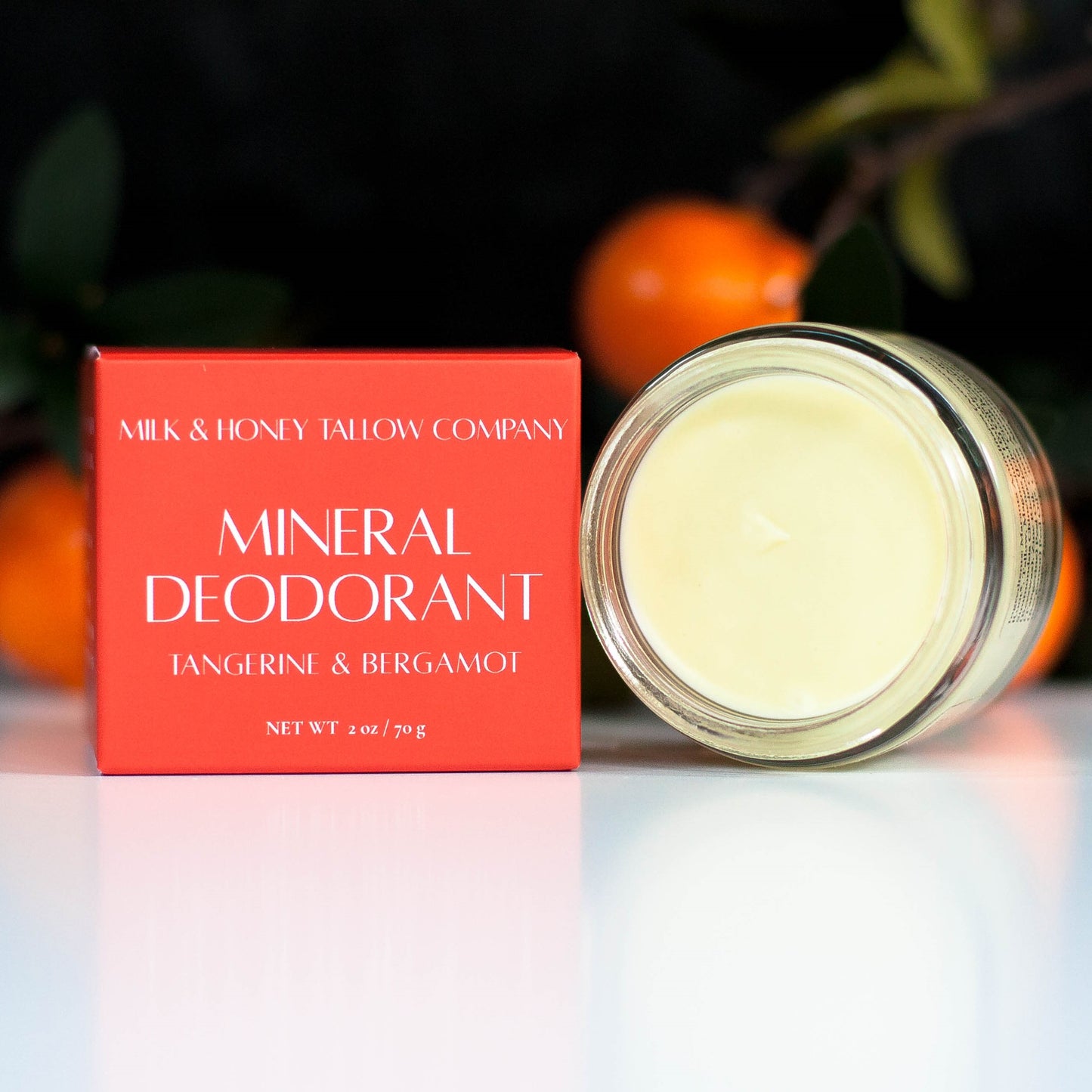 Box and Jar of Tangerine and Bergamot Mineral Deodorant with tangerines in the background