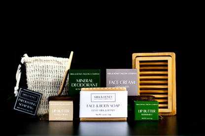 Collection of tallow skincare and body care products on a black background