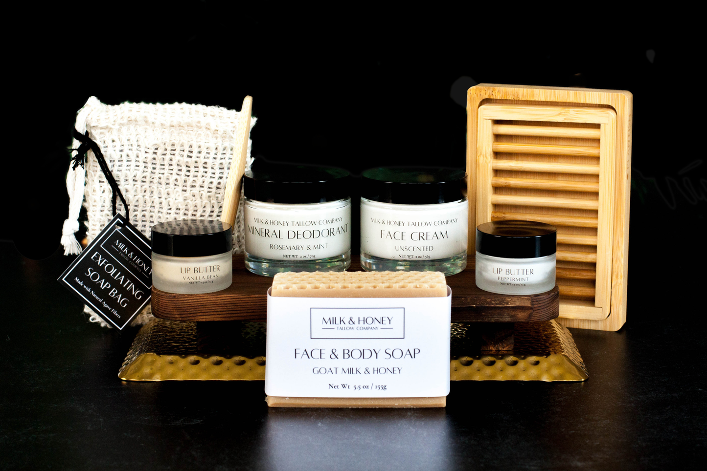 Collection of tallow skincare and body care products on a black background