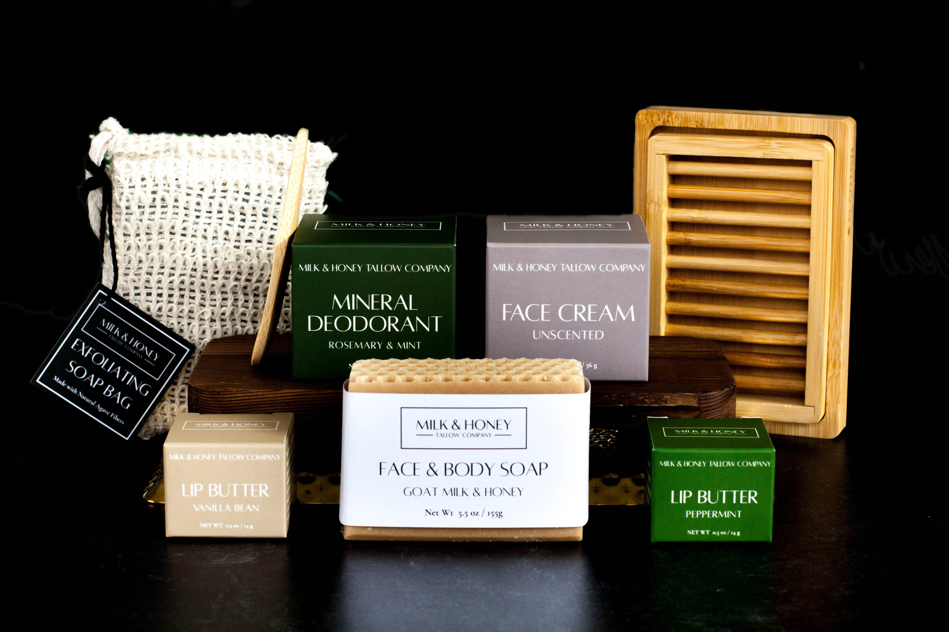 Collection of tallow skincare and body care products on a black background
