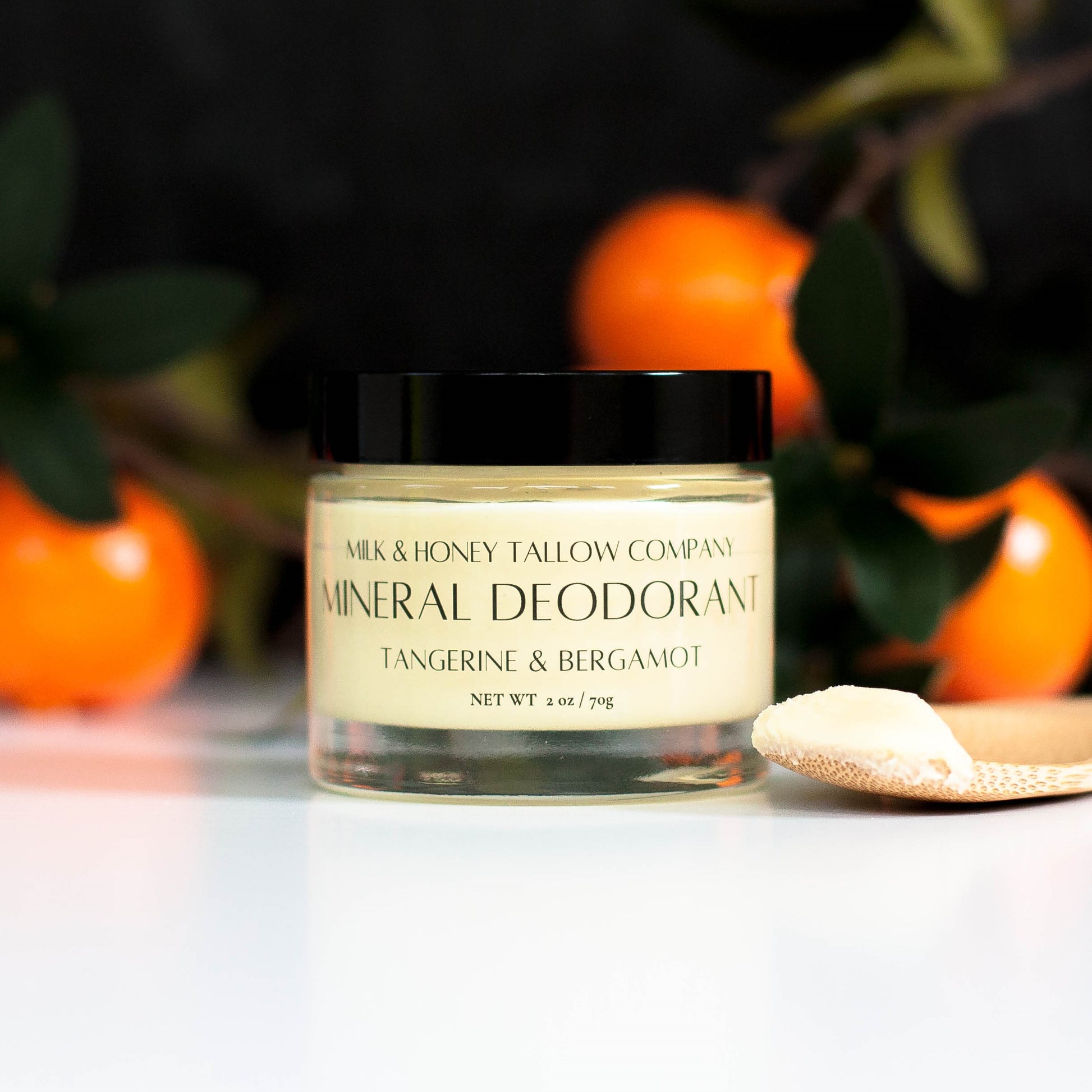 Jar of Tangerine and Bergamot Mineral Deodorant with tangerines in the background