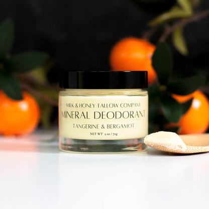Jar of Tangerine and Bergamot Mineral Deodorant with tangerines in the background