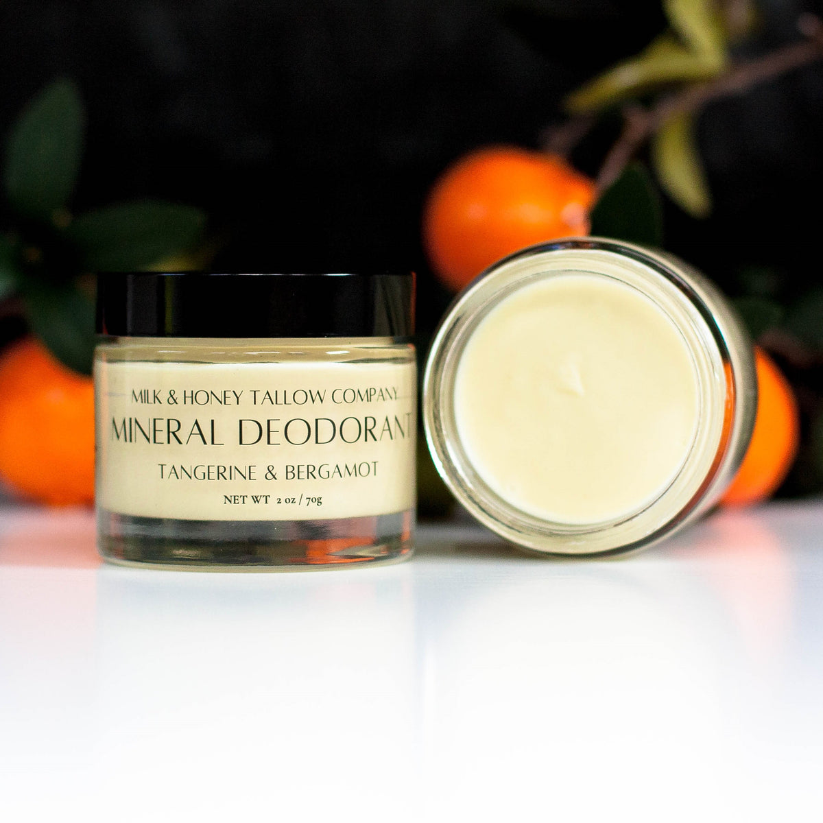 Jar of Tangerine and Bergamot Mineral Deodorant with tangerines in the background