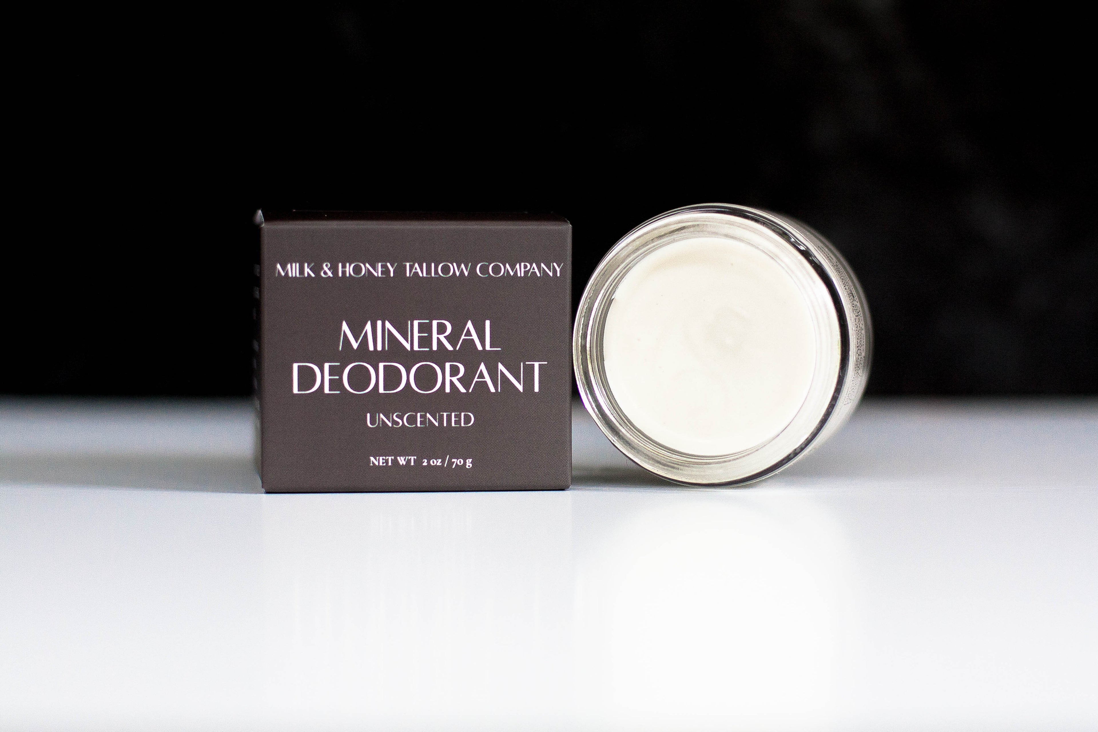 Milk & Honey Tallow Company mineral deodorant on a white surface with a black background