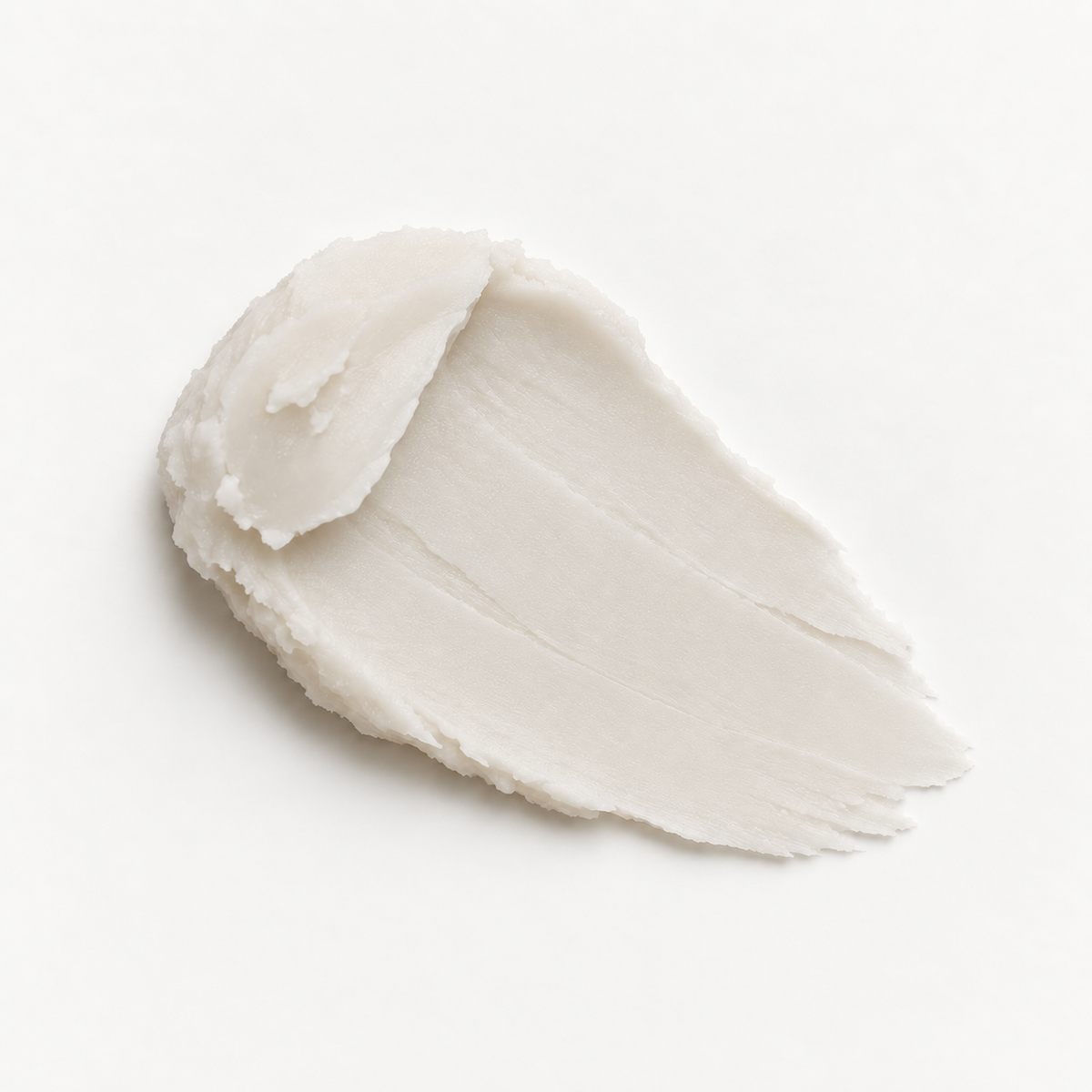 A thick, creamy off-white cosmetic deodorant smear, shown on a clean white background.