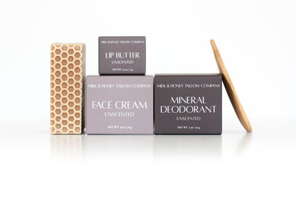 Set of Milk & Honey Tallow Skincare products including tallow face cream, mineral deodorant, tallow lip butter, and goat milk & honey face and body soap on a white background.