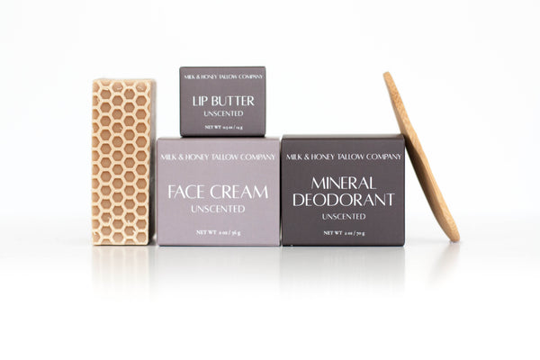 Set of Milk & Honey Tallow Skincare products including tallow face cream, mineral deodorant, tallow lip butter, and goat milk & honey face and body soap on a white background.