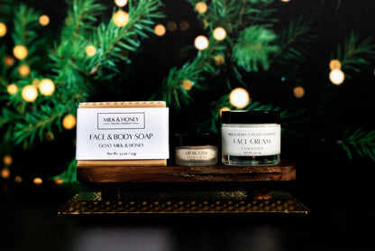 Milk & Honey tallow skincare products on a wooden stand with festive lights and greenery in the background